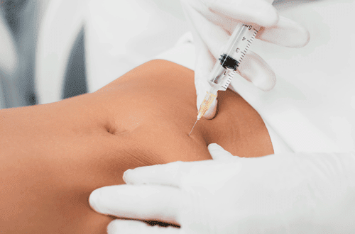 Woman getting fat dissolving injection in tummy