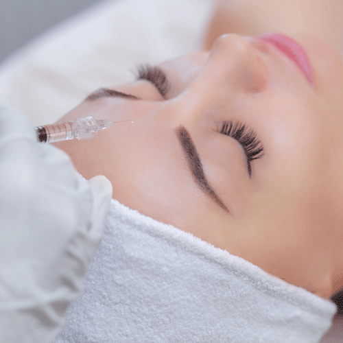 Woman having filler injected into forehead